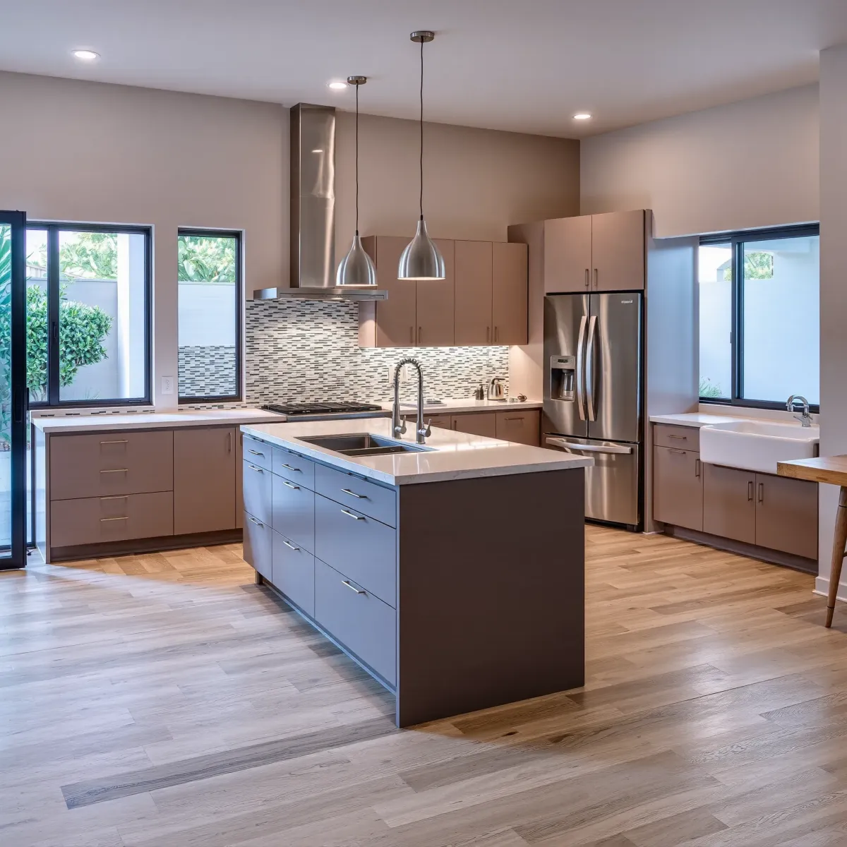 Renovated Newport Heights kitchen with quartz counters, stainless appliances, custom wood cabinetry, and open-concept design.