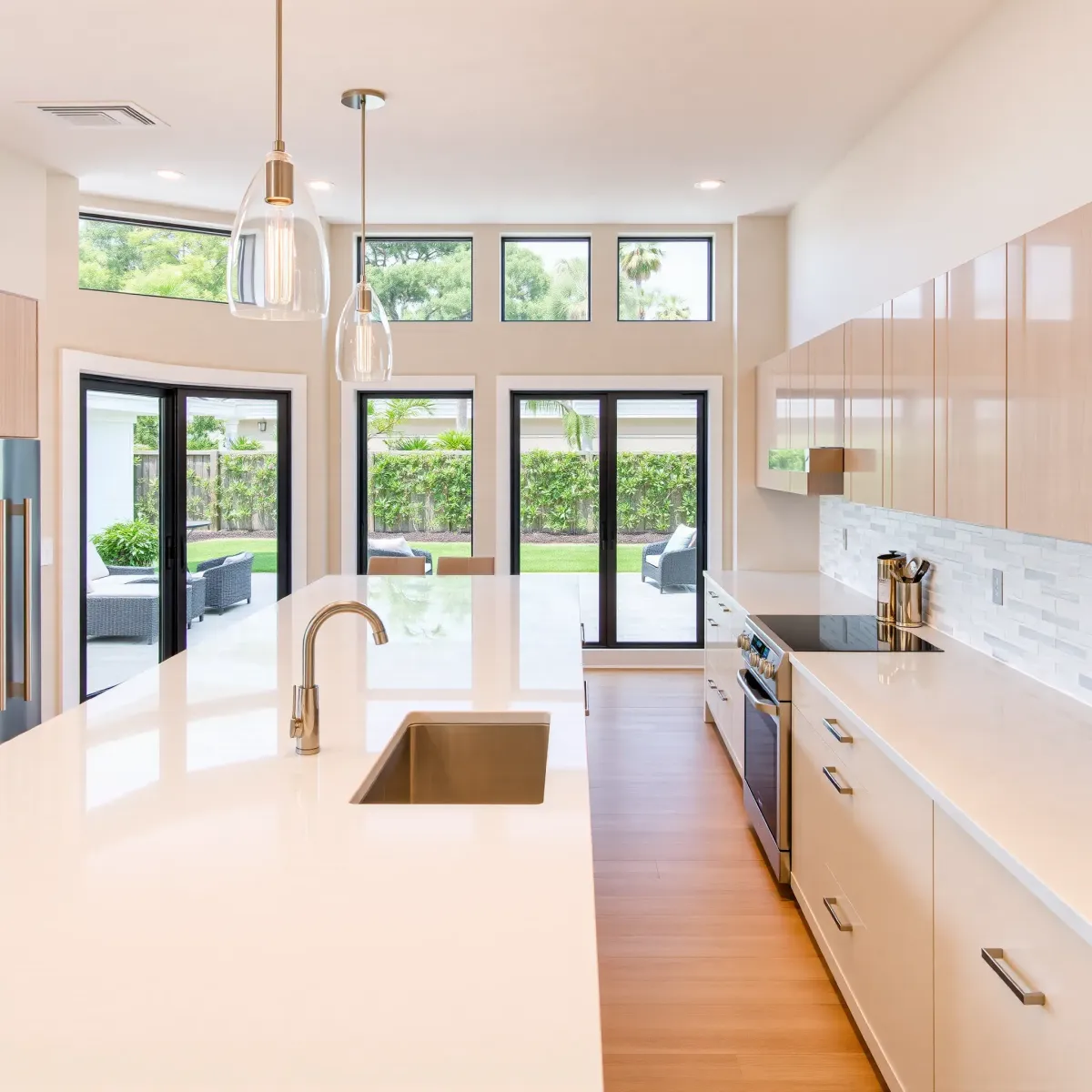 Remodeled South Coast Metro kitchen with modern matte cabinetry, stainless steel appliances, quartz island, hardwood floors, and natural light.