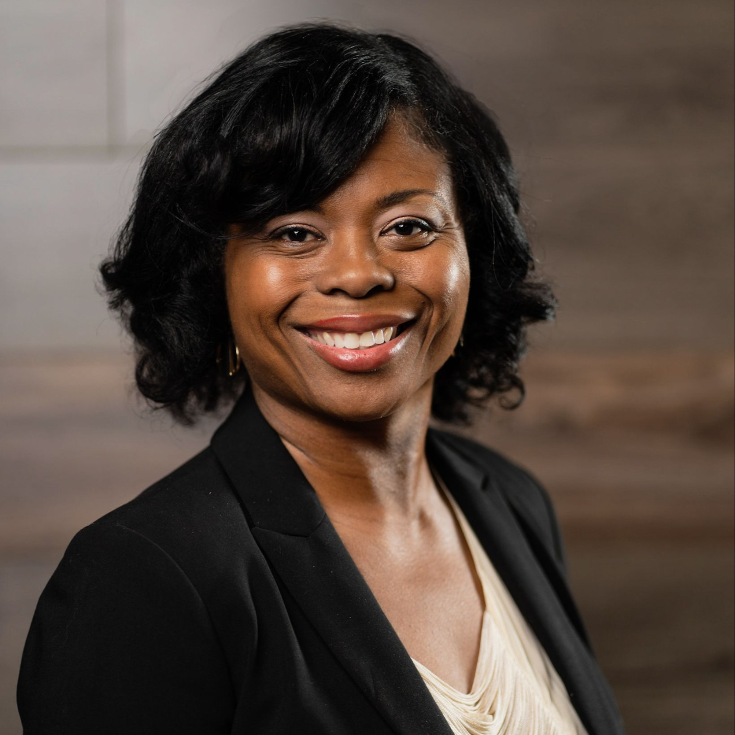 Portrait of Avery Rowan, mid-40s coach, confident half-body in warm studio light, soft gray backdrop, wearing a navy blazer, friendly direct gaze, natural pose — photorealistic headshot for author bio.