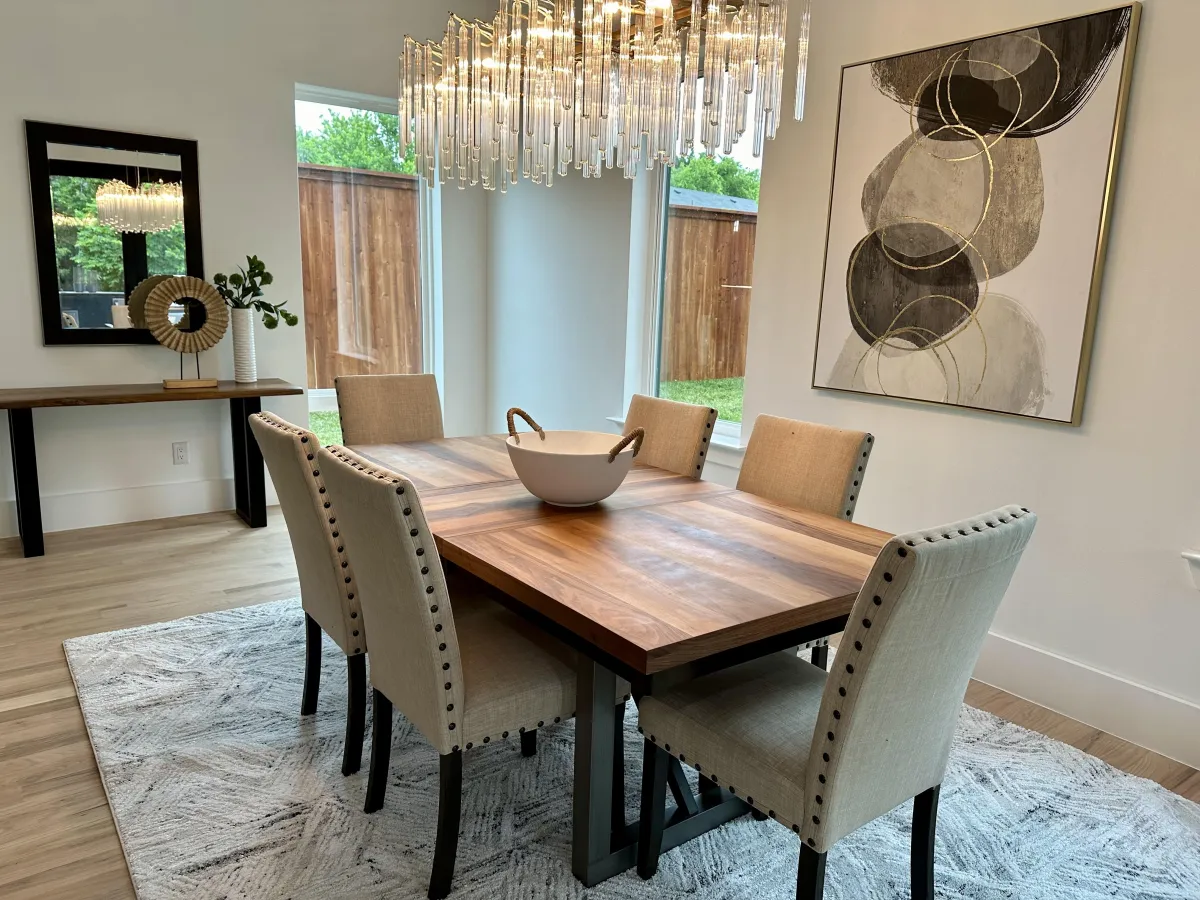 Cozy staged dining room featuring a beautiful chandelier as the focal point, professionally styled by Model My Home—Dallas Fort Worth home staging and interior design experts.