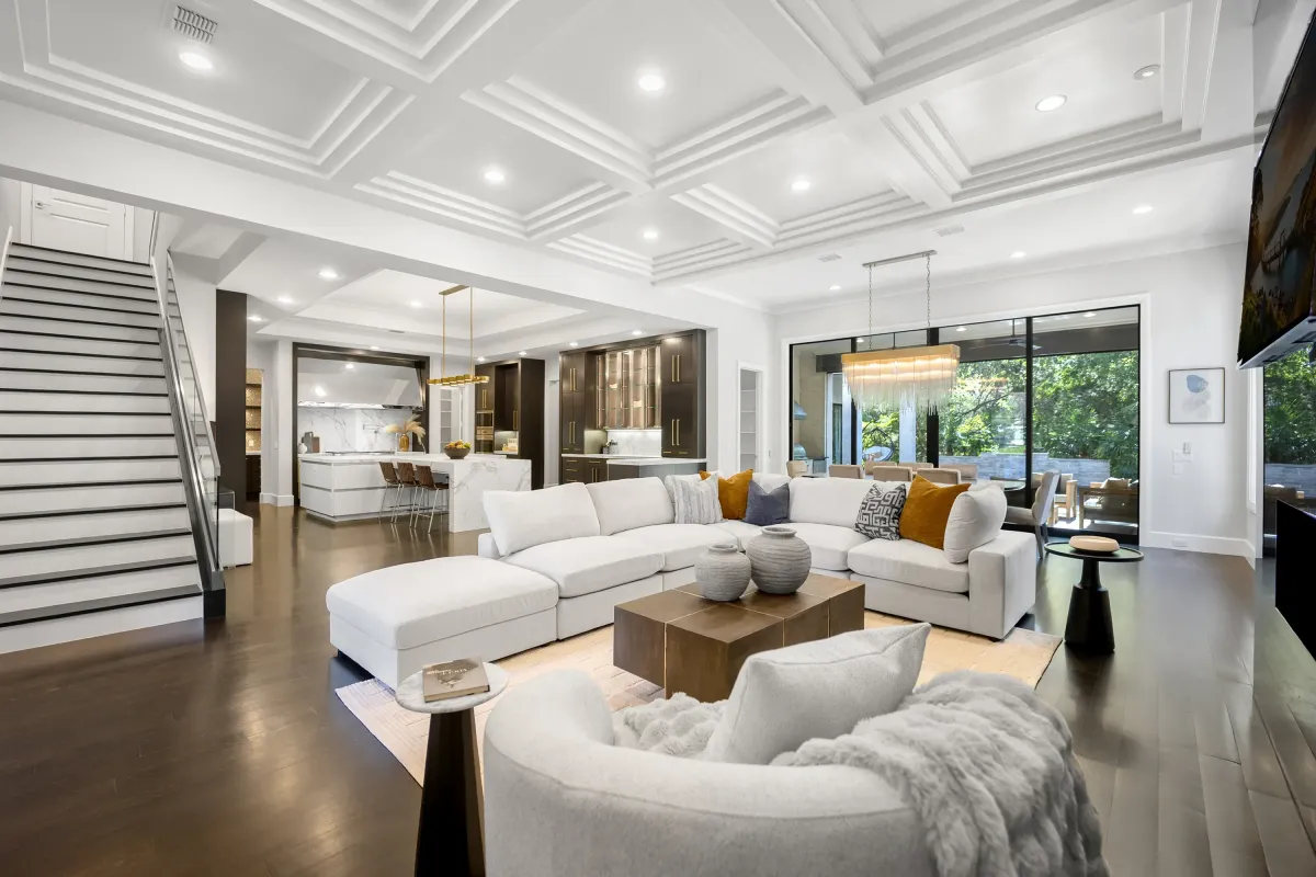 Large, spacious open-concept living room featuring ceiling built-ins as a custom accent, professionally staged by Model My Home—Dallas Fort Worth home staging and design experts.