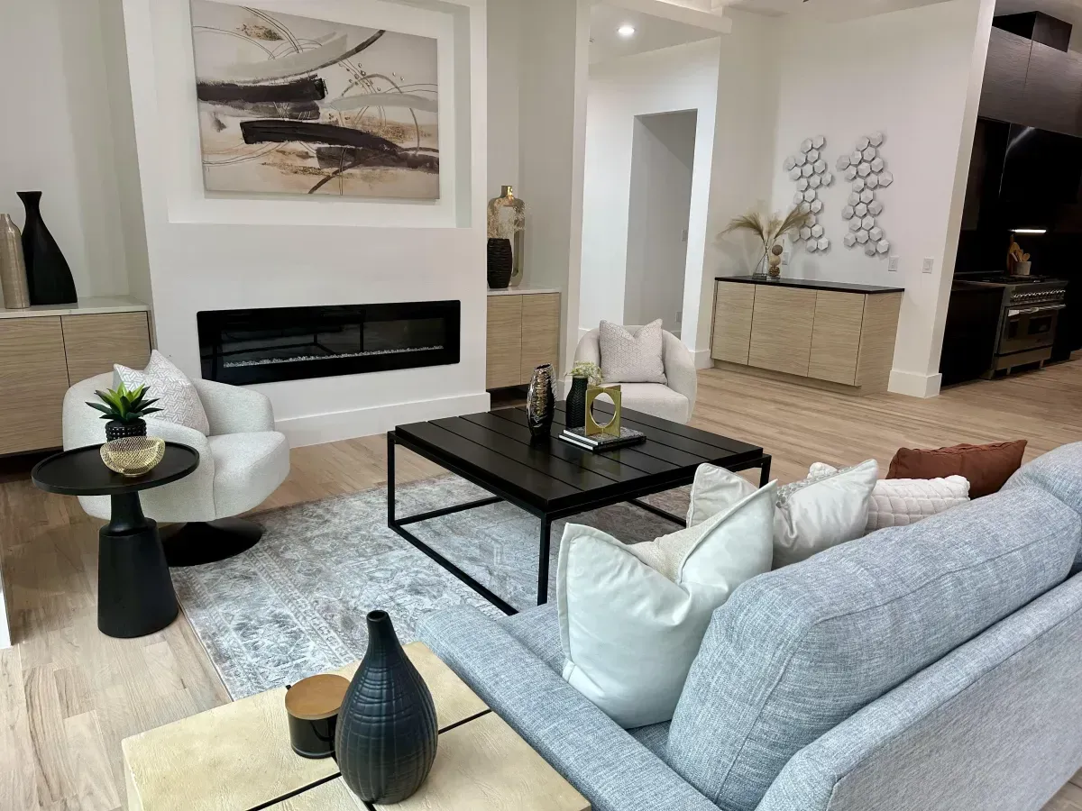Bright, open-concept living room with a smaller layout that feels spacious and connected to the rest of the home, professionally staged by Model My Home—Dallas Fort Worth home staging and design experts.