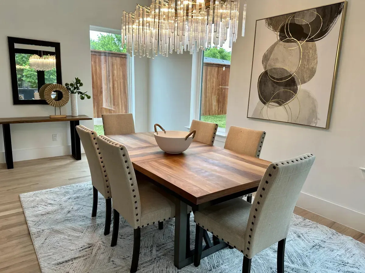 Cozy staged dining room featuring a beautiful chandelier as the focal point, professionally styled by Model My Home—Dallas Fort Worth home staging and interior design experts.
