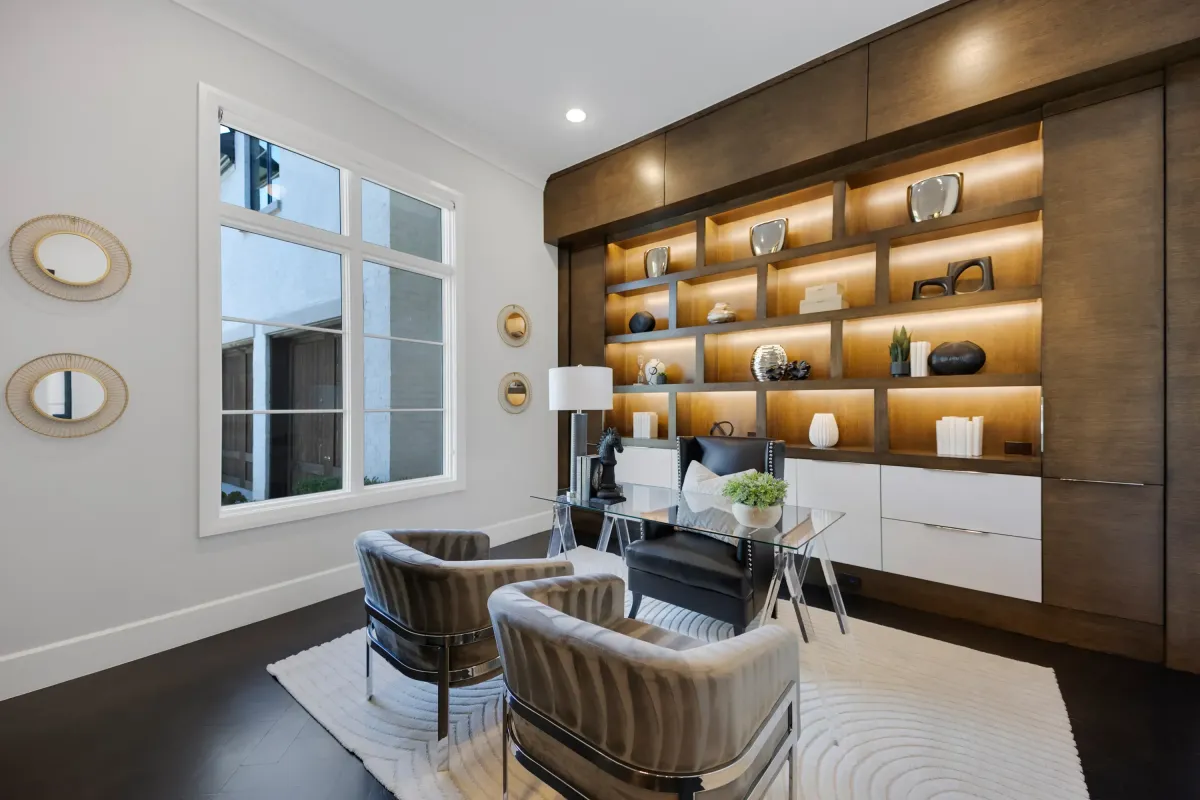 Modern home office featuring a dark wood built-in wall with under-shelf lighting, professionally staged by Model My Home—Dallas Fort Worth home staging and design experts.