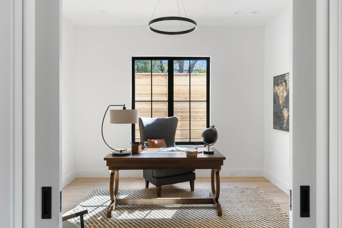 Small staged home office with bright natural lighting, designed by Model My Home to maximize space and make the room appear larger—Dallas Fort Worth home staging and design experts.