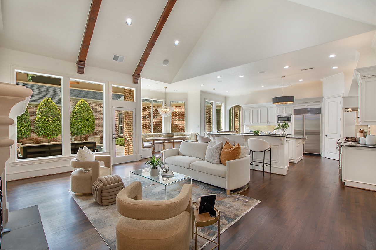 Open-concept living room and kitchen with a full wall of floor-to-ceiling windows, professionally staged by Model My Home—Dallas Fort Worth home staging and interior design experts.
