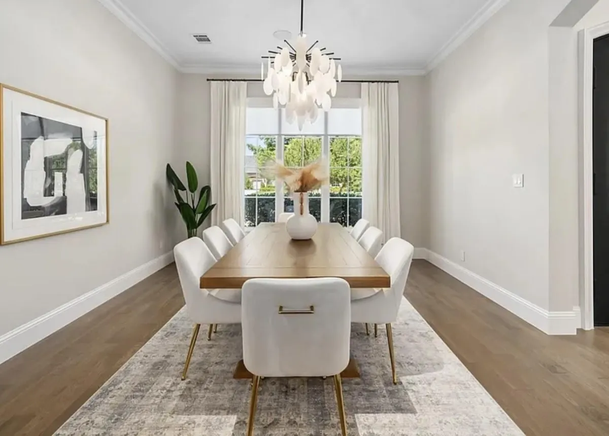 Spacious luxury staged dining room open to the kitchen, filled with natural light and designed to accommodate a ten-plus person dining table—professionally styled by Model My Home, Dallas Fort Worth home staging and design experts.