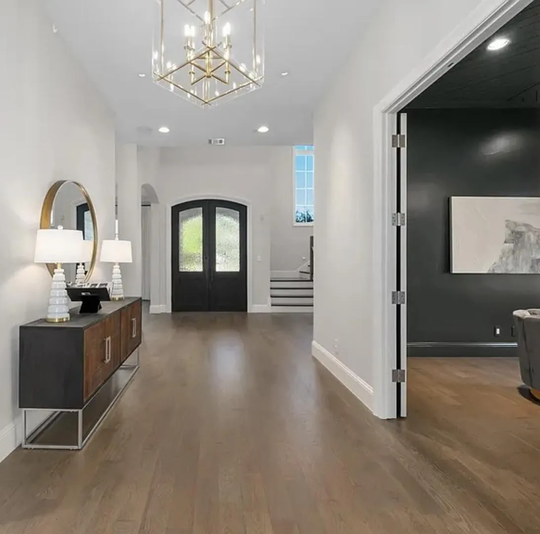 Spacious entryway opening into a wide hall and open-concept home, professionally staged by Model My Home—Dallas Fort Worth home staging and interior design experts.