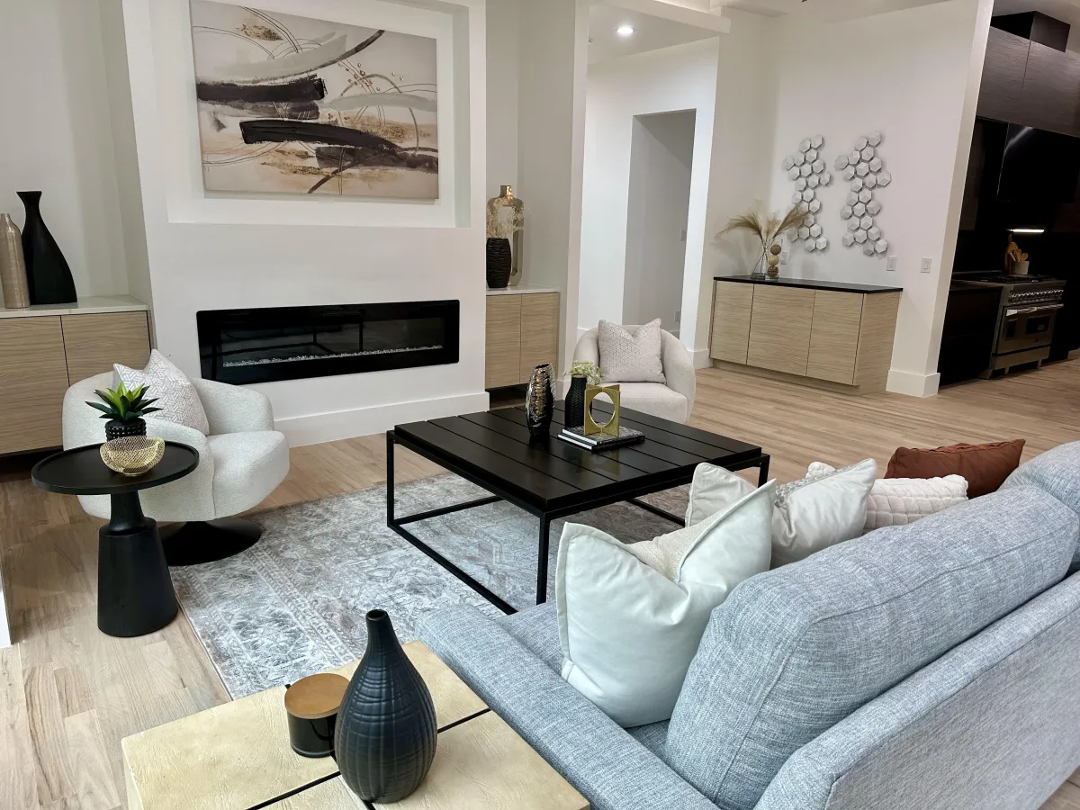 Bright, open-concept living room with a smaller layout that feels spacious and connected to the rest of the home, professionally staged by Model My Home—Dallas Fort Worth home staging and design experts.