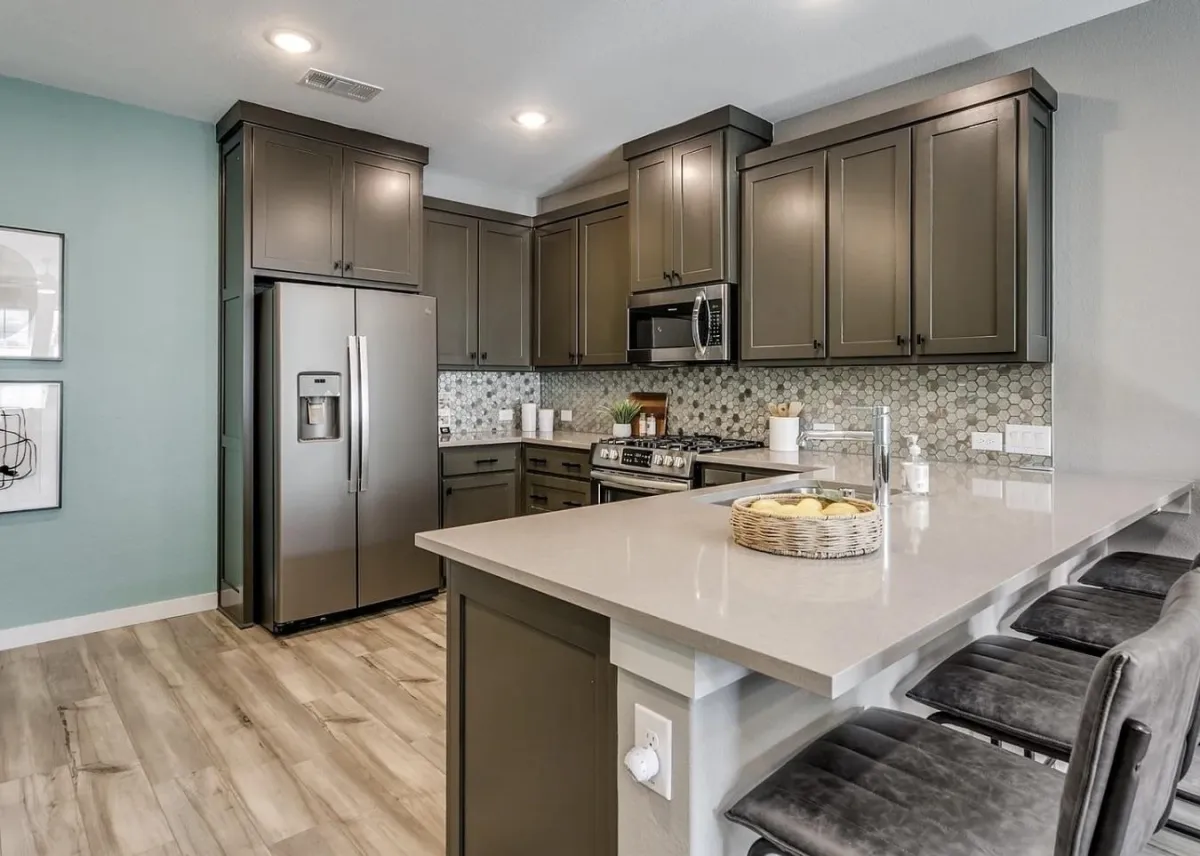 Modern short-term rental kitchen fully equipped with essential appliances, cookware, and supplies for guests, professionally staged by Model My Home—Dallas Fort Worth home staging and design experts.