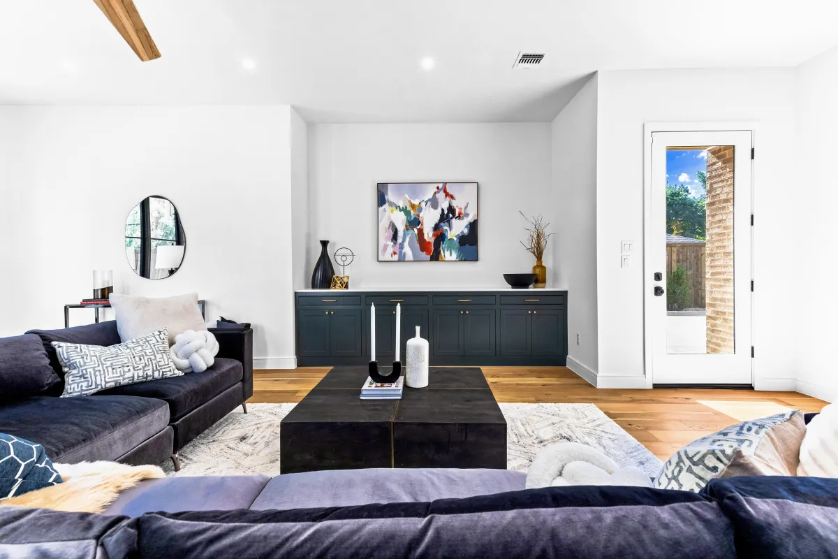 Bright, cozy staged living room with modern décor, designed by Model My Home to make a smaller space feel open and inviting—Dallas Fort Worth home staging experts.
