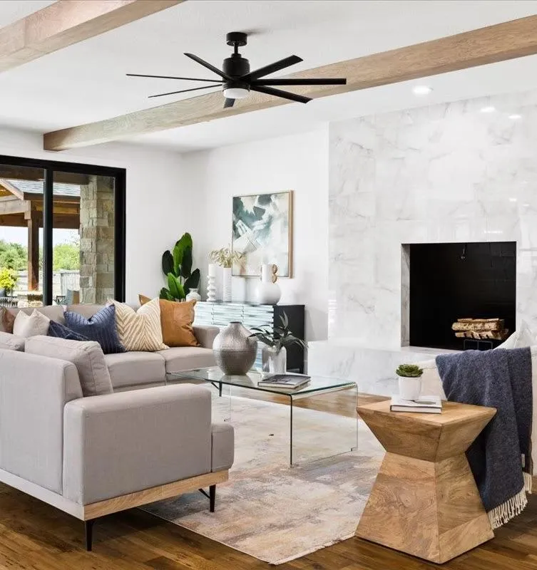 Bright open-concept living room featuring a striking marble fireplace as the focal point, professionally staged by Model My Home—Dallas Fort Worth home staging and design experts.