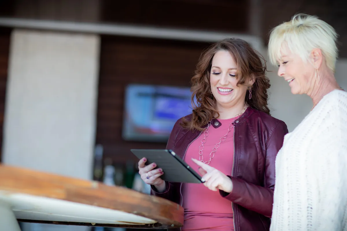 Event planner reviewing business strategy with laptop and notebook