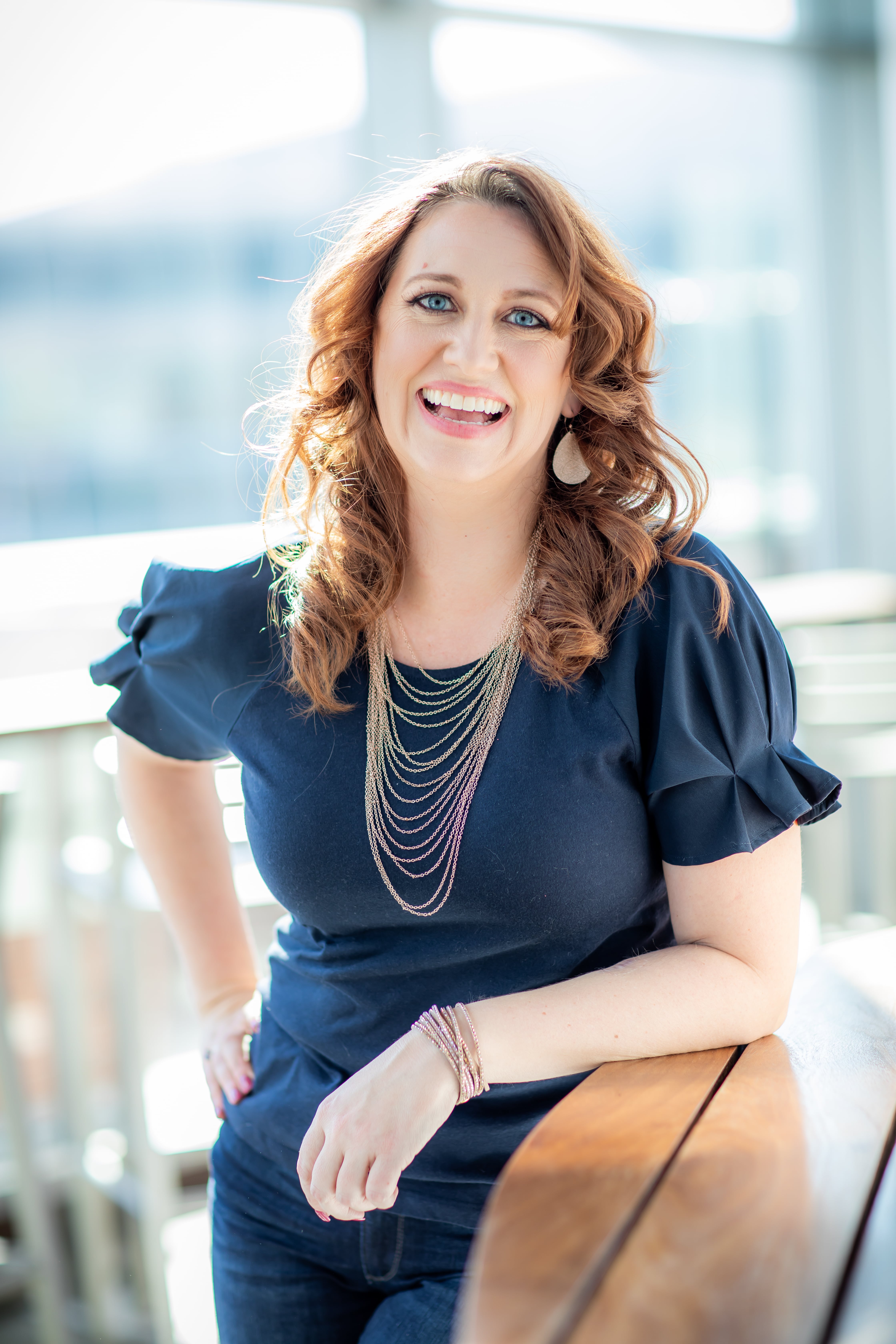 Event planner reviewing business strategy with laptop and notebook