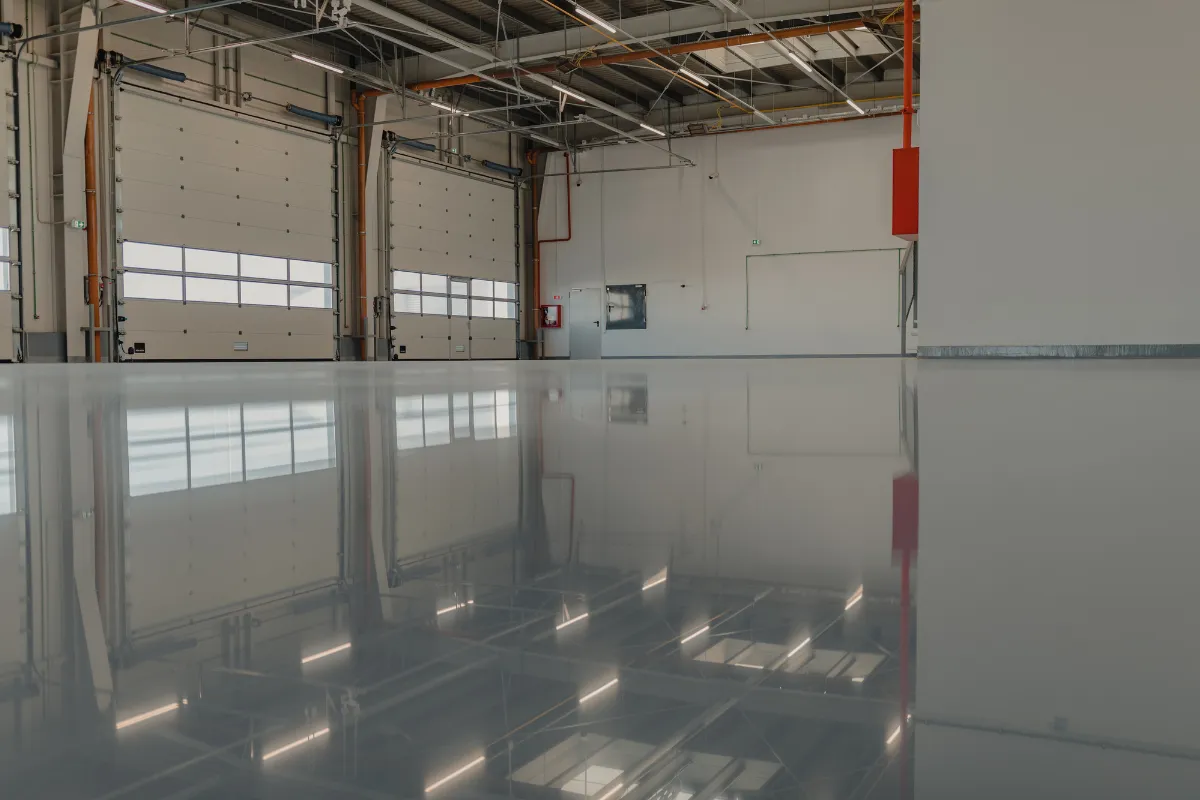 Commercial hangar with gray epoxy floor and large garage doors