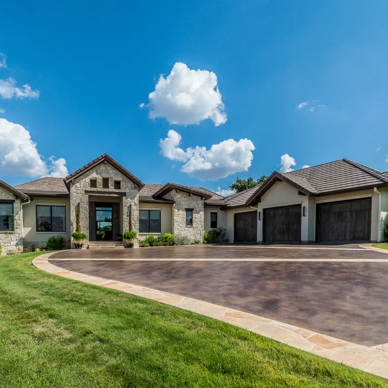 Custom stained concrete driveway with polished brown finish