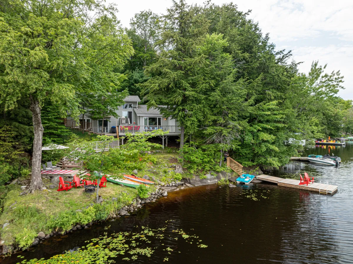 a body of water surrounded by trees and houses