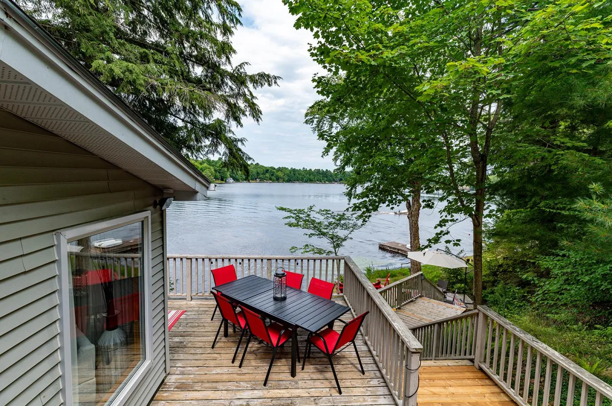 a body of water surrounded by trees and houses