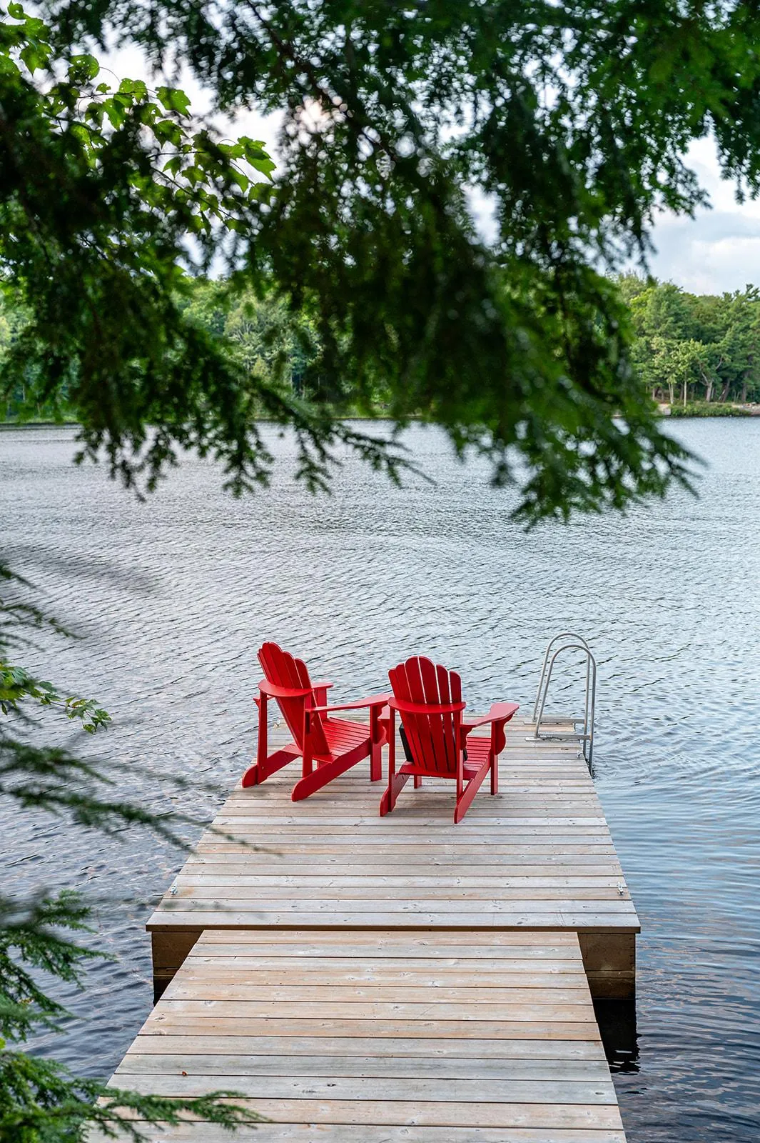 Private dock and fire pit at a Port Carling Muskoka cottage rental with complimentary kayaks for guests