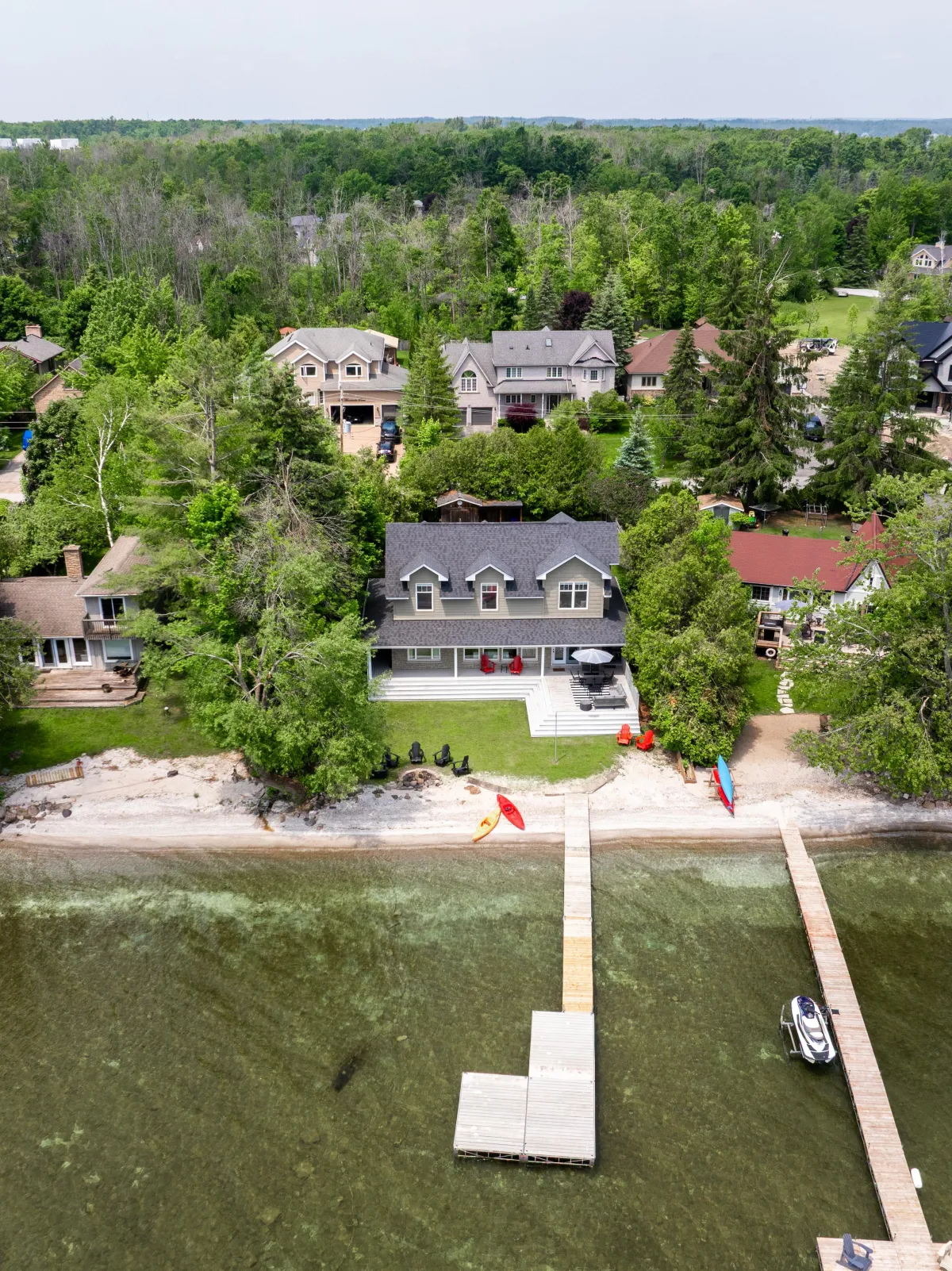 a body of water surrounded by trees and houses