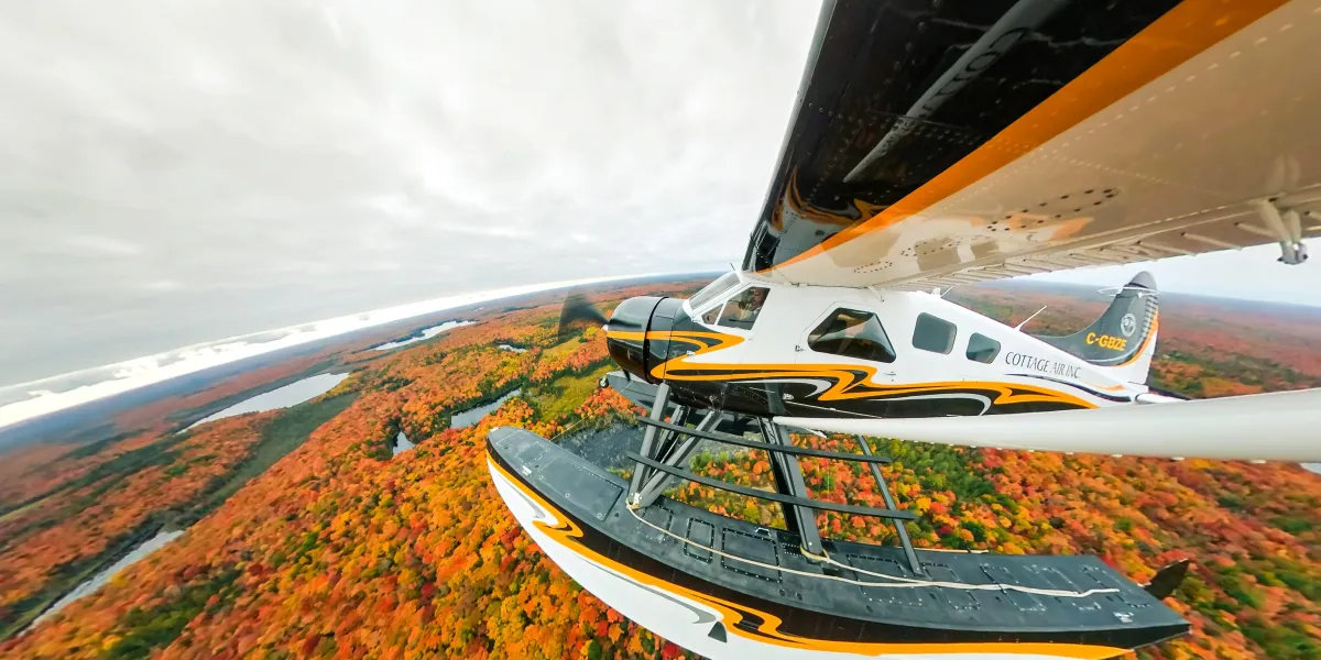 Stunning autumn fall foliage in fiery red and gold colours reflecting on a Muskoka lake
