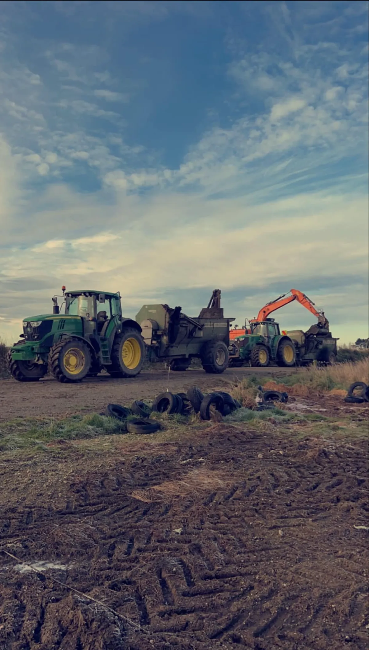 Three tractors wrapping baleage in Southland paddock