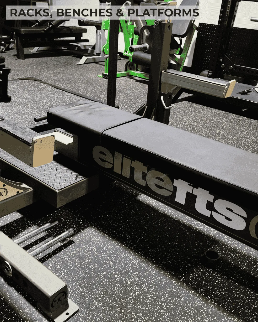 EliteFTS competition bench press and Rogue Monster steel racks inside The Strength Lab powerlifting facility in Newtown, Connecticut.