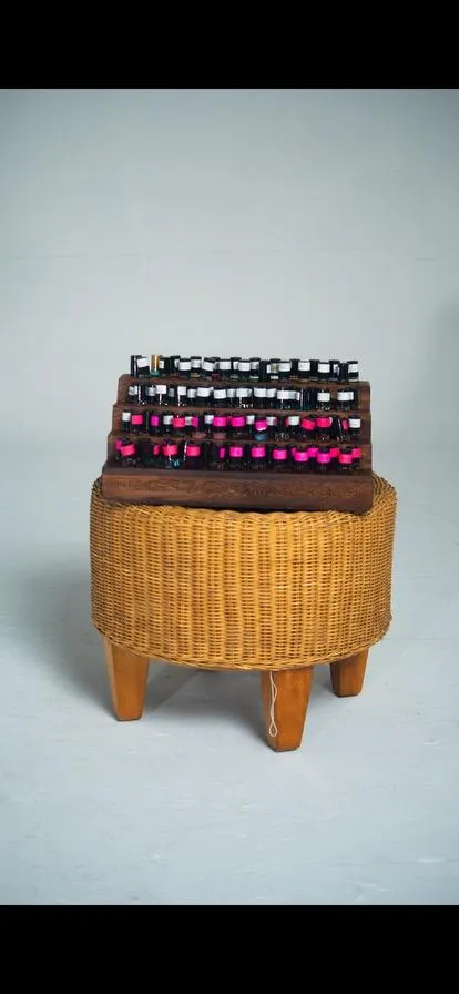 Close-up product composition with textured box, ribbon, and bottle on linen surface.