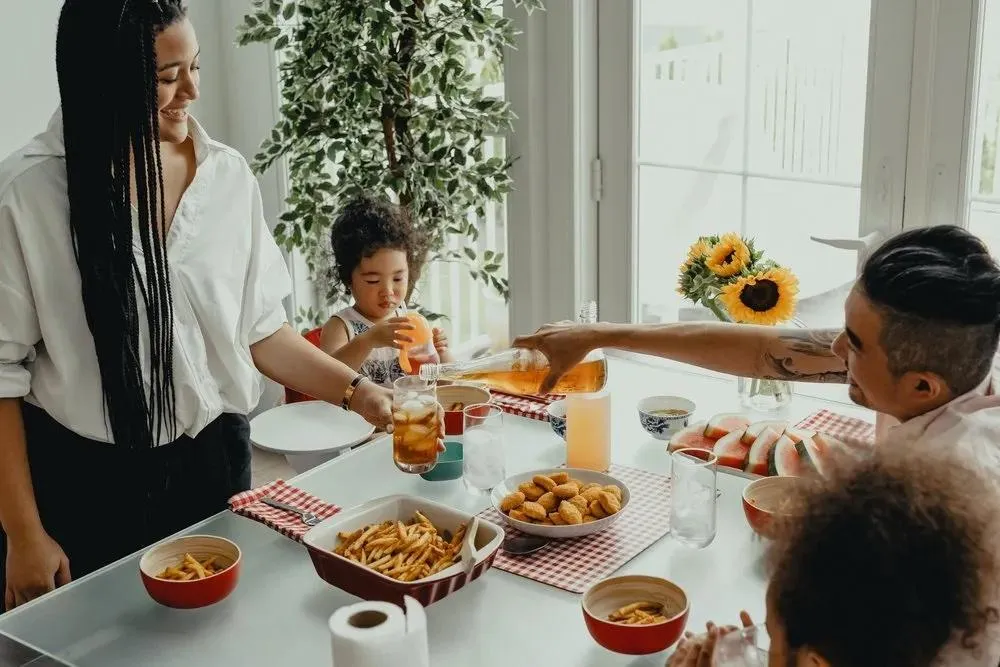 A joyful family gathered around the table, sharing a meal and creating cherished memories together.