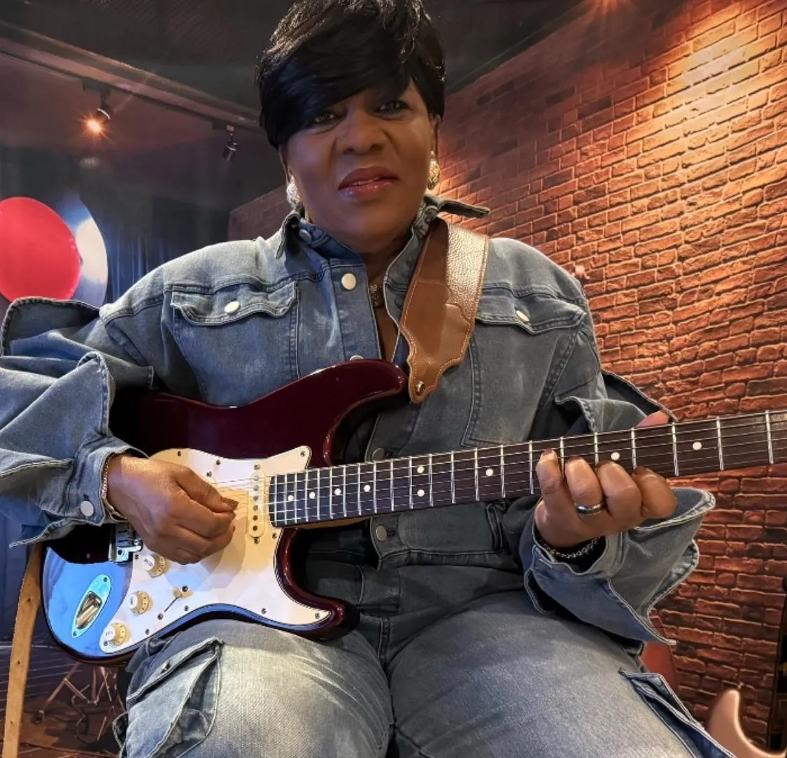 Dr. Glenice Glover playing guitar