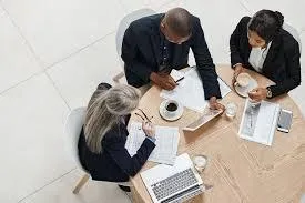 a black and white photo of a clock on the side of a building