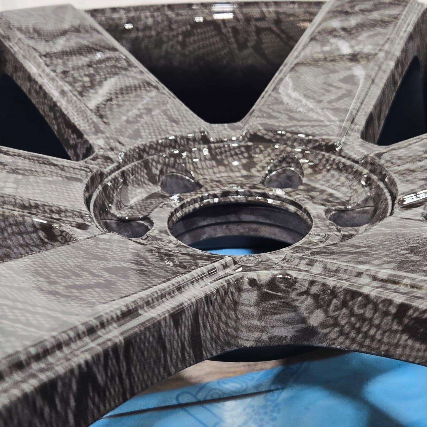 Close-up of wheel rim coated in grey snakeskin hydrographic pattern