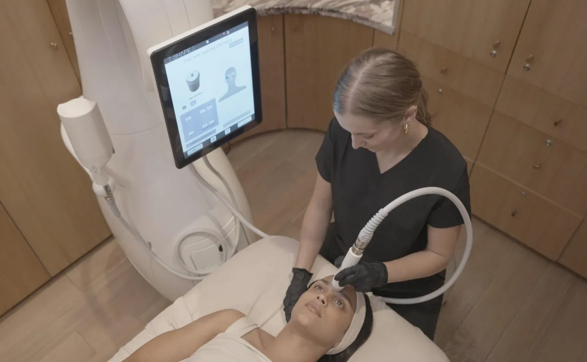 Professional administering a facial anti-aging treatment using an FDA-approved T-Shape 2 device in a serene spa setting, emphasizing comfort and effective skincare