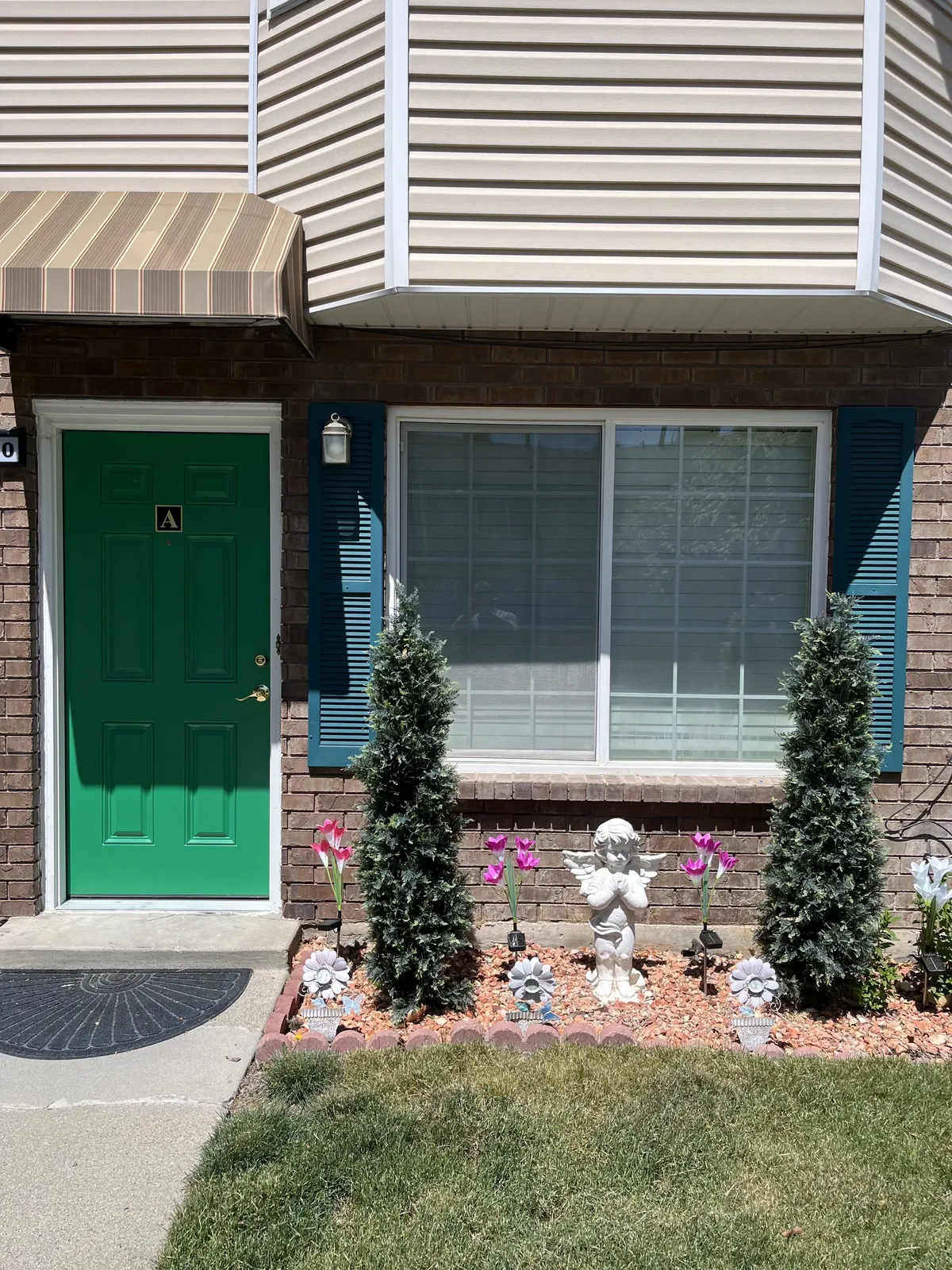 Home exterior with a new green front door and window