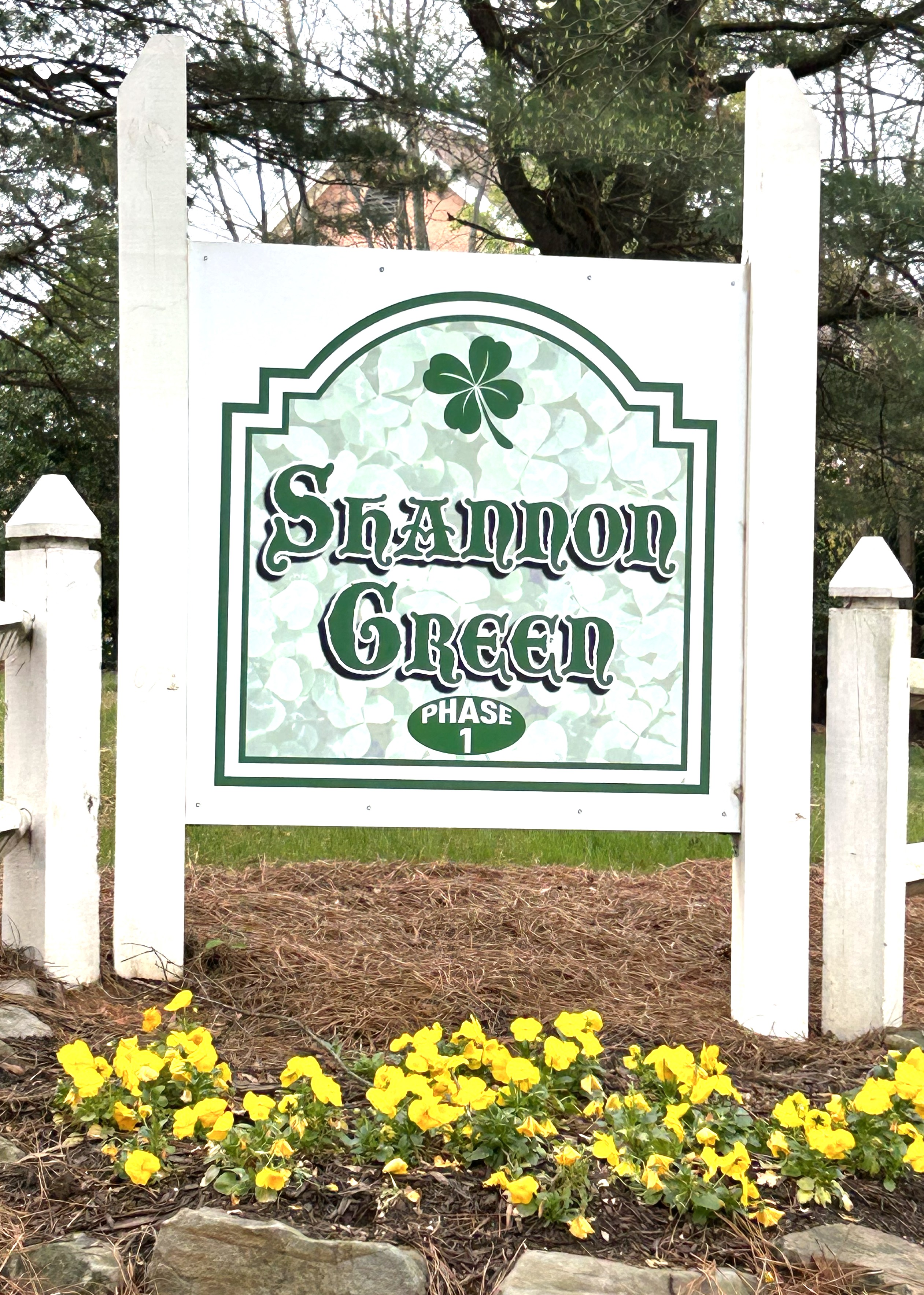 a living room with white furniture and wood floors