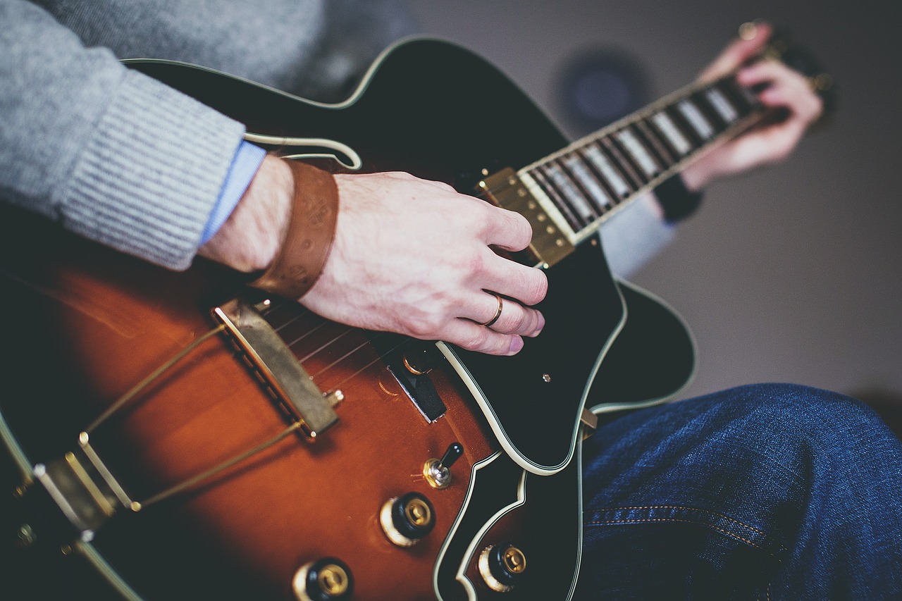 Close up of man playing electric guitar