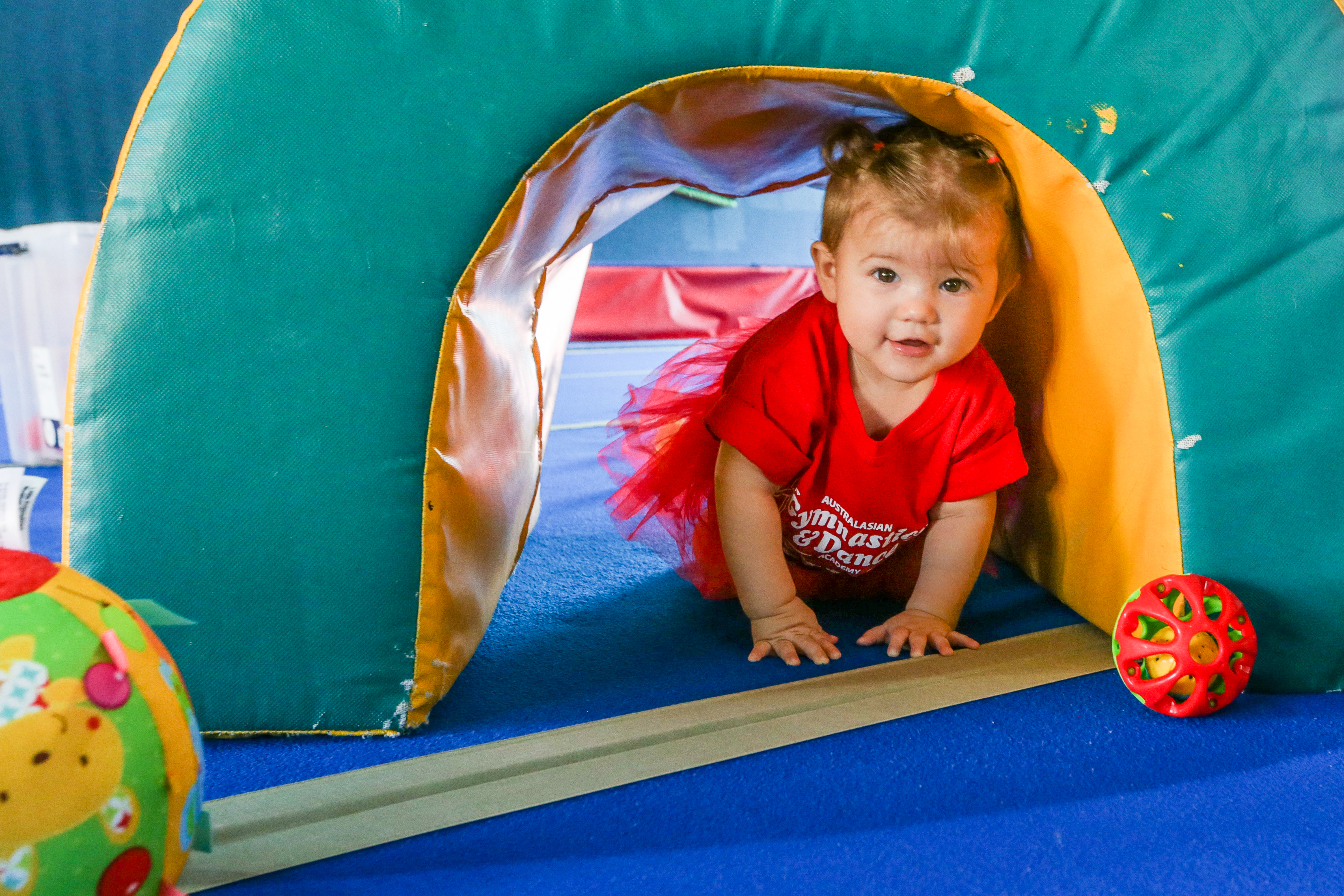 a woman holding a pole in a pool with people around her