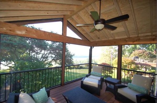 Patio roof with wood beams and shingle roofing built over a backyard deck