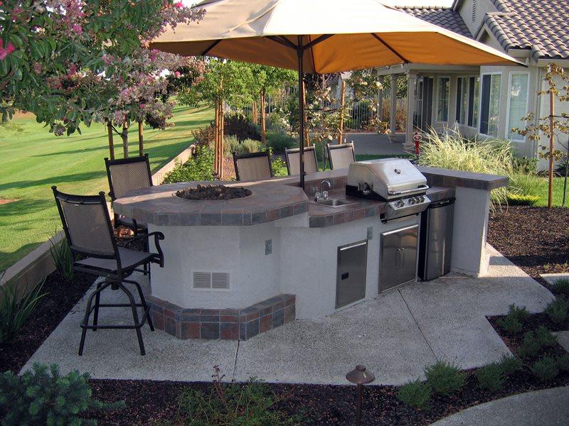 Custom outdoor kitchen with built-in grill and stone counters in Colorado