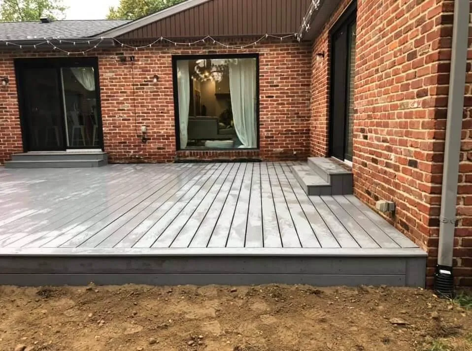 Composite deck being installed over pressure-treated frame in Colorado