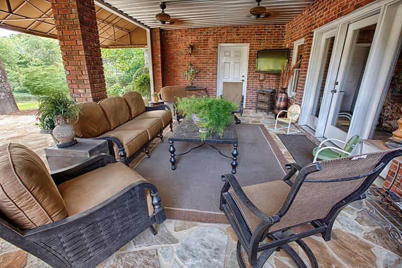 Covered deck with gable roof and outdoor seating in Colorado backyard