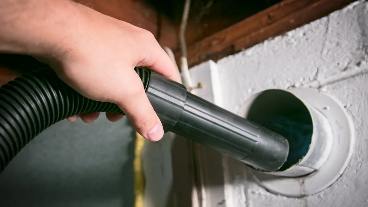 person holding yellow plastic spray bottle