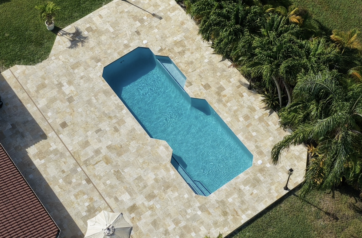 Robotic lawn mower by a swimming pool