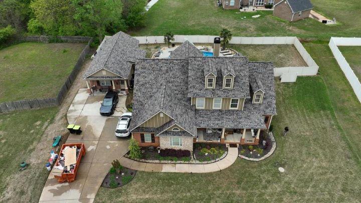 Eco-friendly roof replacement on two-story home in Griffin, Georgia by Elite Roofing & Outdoor Construction — energy-efficient roofing materials