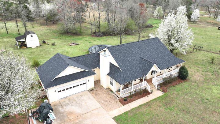 Country-style home with new metal roofing in Riverdale, GA installed by Elite Roofing & Outdoor Construction — long-lasting and weather-resistant