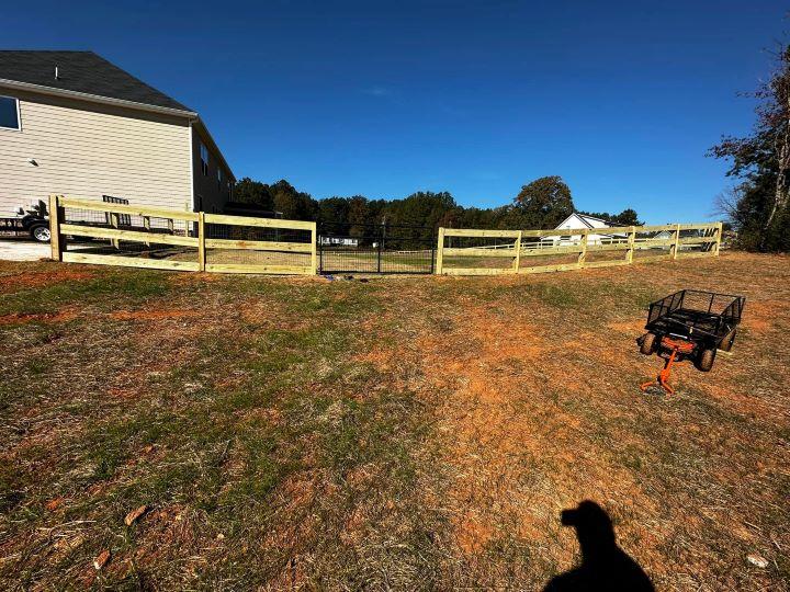 Custom-built wood fencing project in Conyers, Georgia by Elite Roofing & Outdoor Construction — privacy and curb appeal solution