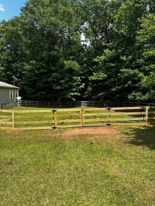 Wooden privacy fence installed in Griffin, GA by Elite Roofing & Outdoor Construction — custom fencing for yard security and style