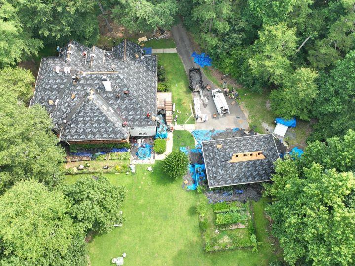 Active roof replacement site in Stockbridge, GA showing construction materials and install progress by Elite Roofing & Outdoor Construction