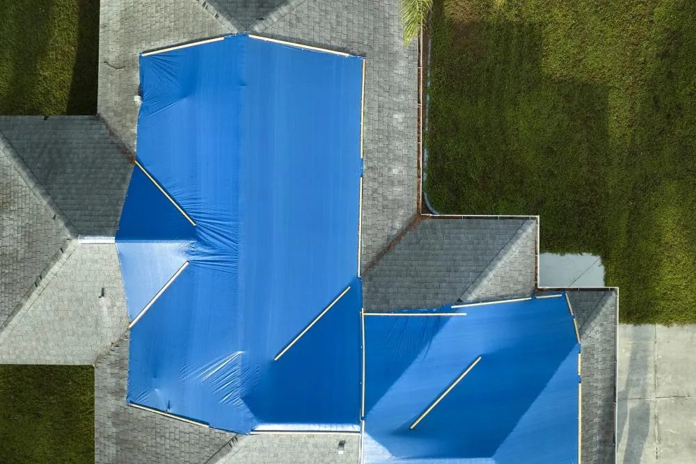 Emergency roof tarping in Riverdale, GA by Elite Roofing & Outdoor Construction — storm protection with durable blue tarp installation