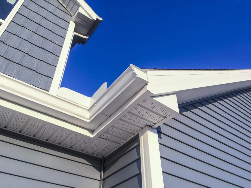 Custom-fit white gutter installation in Fayetteville, GA by Elite Roofing & Outdoor Construction — long-lasting water drainage protection